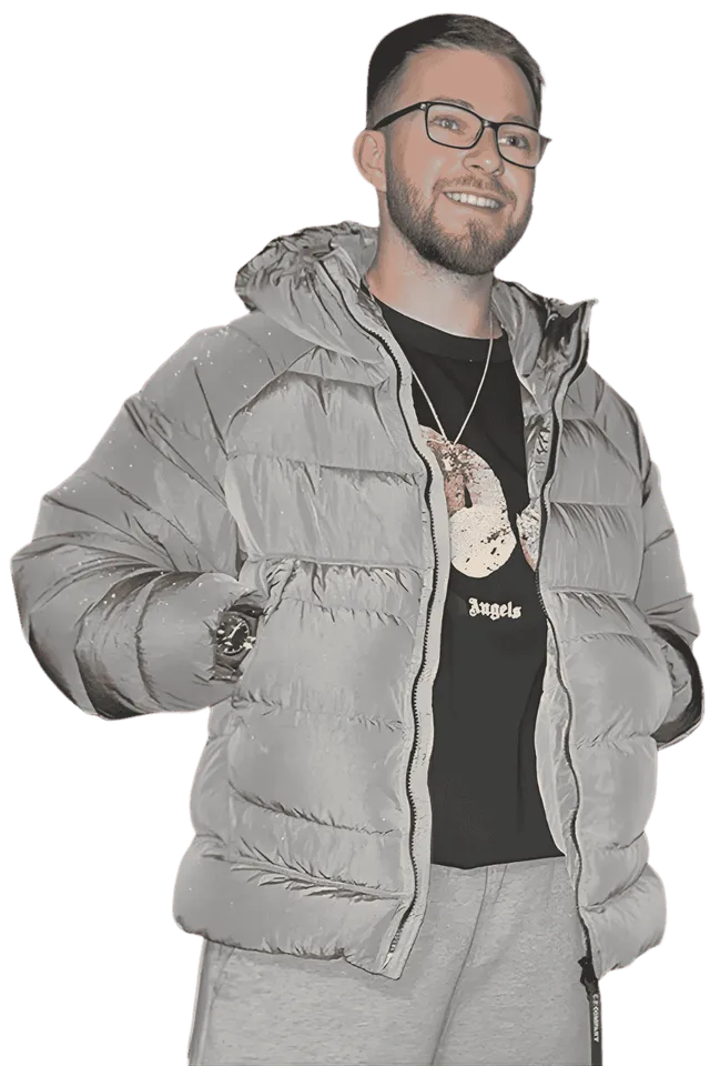 Will Staton smiling, in glasses and a grey puffer jacket